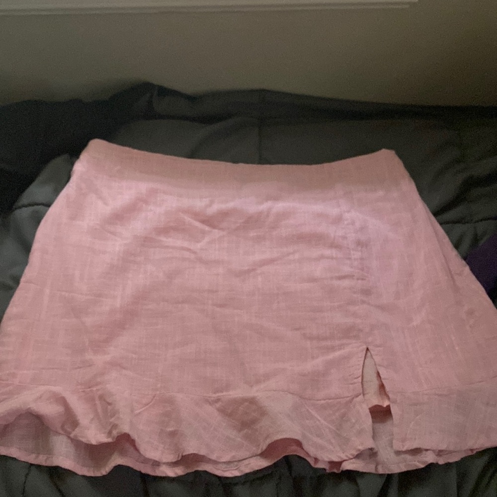 Pink mini ish skirt still has white strings to hang it!